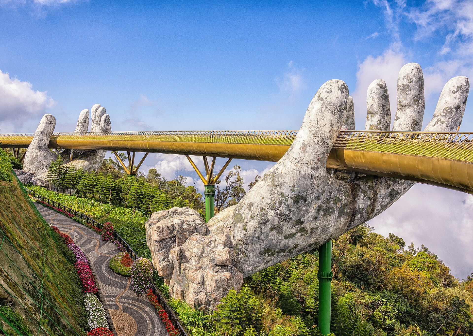 The Golden Bridge held aloft by giant stone hands at Ba Na Hills, Da Nang, Vietnam